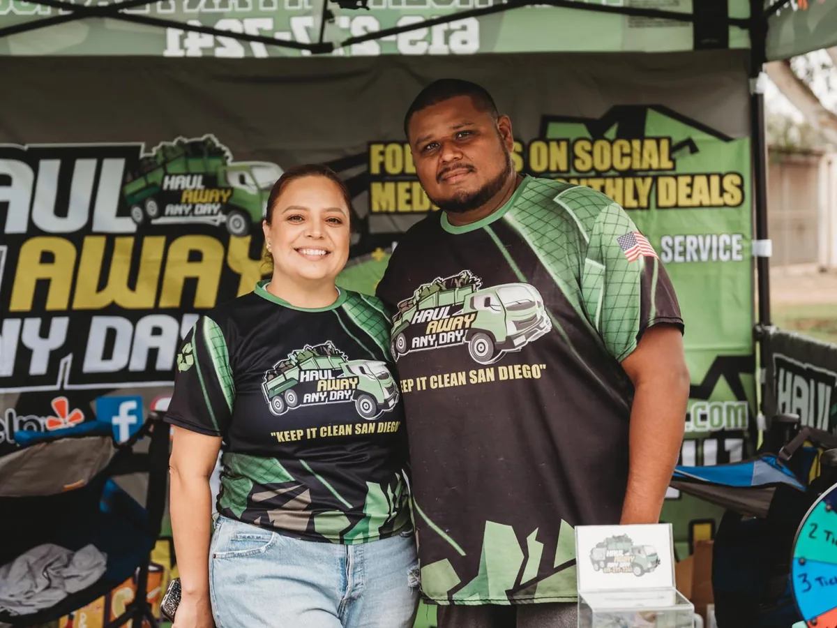 The owners of Haul Away Any Day at their booth during a community event