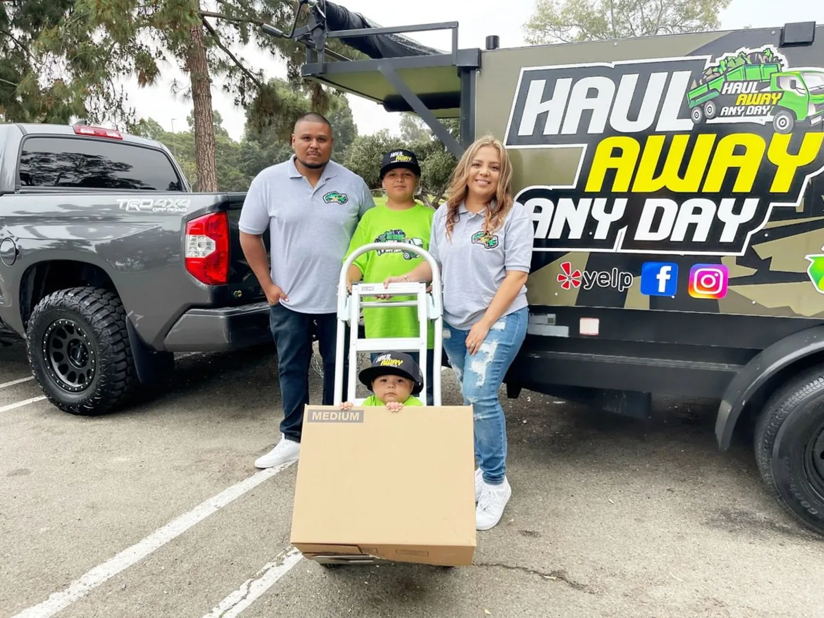 The family behind Haul Away Any Day with their trailer
