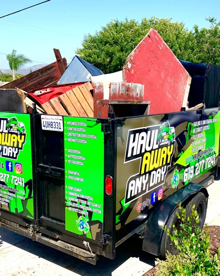 Haul Away Any Day trailer loaded with furniture and household junk
